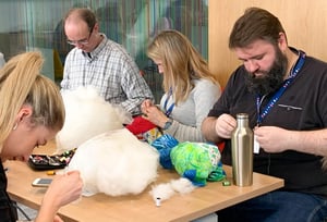 Congenica team stitching their RARE Bears for Rare Disease Day